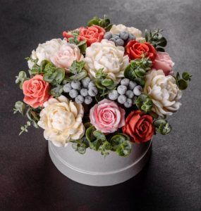 Bouquet of beautiful bright rose flowers in a gift cylindrical cardboard box